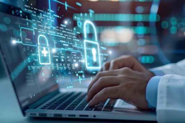 Doctor using a laptop with digital security graphics overlay, representing data protection and cybersecurity in healthcare.